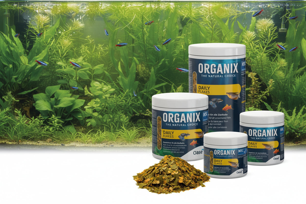 Organix fish food products on with a fish tank in the background